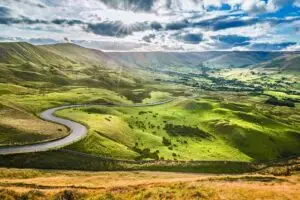 winding road and green valley in the lake district in England.