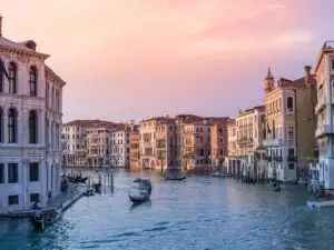 Gondolas and small boats on canal tour in Venice.