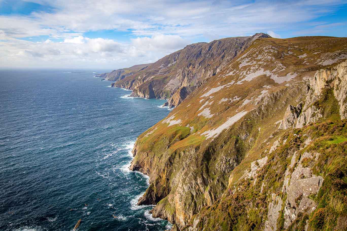 clients on a UK tour standing on mountain in Slieve League, Ireland.